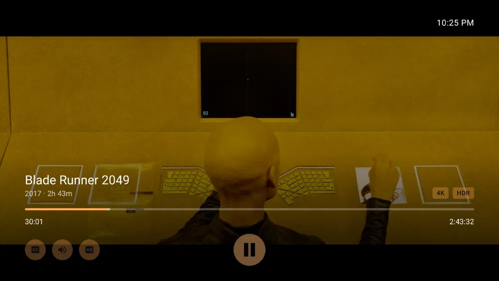 Blade Runner 2049 playing on Google TV, paused mid-scene, with the transport overlay — scrubber, time remaining, 4K and HDR badges, and audio and subtitle controls.